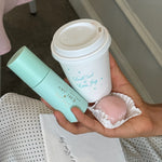 Aura Hair + Body Mist™ in Mochi Milk model holding aura mist, coffee, and treat