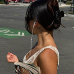 Big Effing Clip in Vogue model walking on the street with wired headphones, Vogue magazine, and Big Effing Clip in Vogue in hair