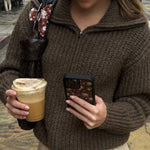 Big Effing Clip in Brown Floral Big Effing Clip in Brown Floral clipped to bag while model holds phone with WIldflower case
