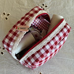 Gingham Pouch in Cherry Kiss Gingham Pouch in Cherry Kiss with assorted hair care and accessories