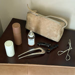 Hair Pin in Tiara Assorted Emi Jay hair care and accessories with styling tools and bag on table.