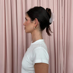 Half Moon Clip in Pink Smoke profile view of model wearing Half Moon Clip in Pink Smoke in front of pink curtain