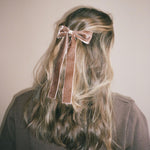 Iconic Velvet Bow Barrette in Mocha Mousse Model wearing Iconic Velvet Bow Barrette in Mocha in hair.