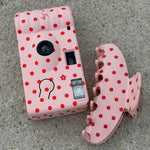 Lychee Baby Disposable Camera Lychee Baby Disposable Camera next to big effing clip on sand