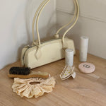 Mini Boar Bristle Brush in Lemon Sugar mini boar bristle brush in lemon sugar with eyelet scrunchie, angelstick, big effing clip, and heavenly hair milk