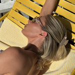 Sweetheart Clip in Two Scoops elsa hosk laying on chair with Sweetheart Clip in Two Scoops in hair