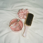 Angel Ashtray Angel Ashtray with hair pins, popstar clips, rose tan silk scrunchie, and pink sugar mini boar brush