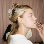 Popstar Clips in Lilac Smoke model wearing Popstar Clips in Lilac Smoke and big effing clip while having makeup applied