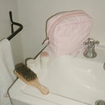 Angel Pouch in Rose Milk Angel Pouch in Rose Milk on bathroom sink next to mini boar brush in leche and angelstick