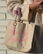 Aura hair mist tote bag with keychain and Sweetheart Clip attached to strap