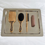 Bamboo Paddle Brush in Toasted Sugar Emi Jay Aura Hair + Body Mist in Toasted Sugar with assorted brushes on tray.