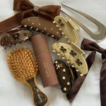 Big Effing Clip in Toasted Sugar Assorted Emi Jay hair accessories, styling tools, and Aura Hair + Body Mist in Toasted Sugar.