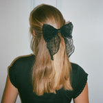 Bow Barrette in Sheer Noir model wearing Bow Barrette in Sheer Noir in hair