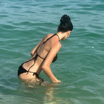 Camellia Clip in Midnight model in ocean with Camellia Clip in Midnight in hair