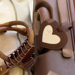 Free Gift: EJ Winter Getaway Luggage Tag luggage tag attached to suitcase next to bag with big effing clip on strap