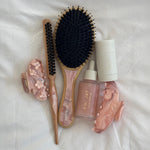 Styling Brush in Pink Chantilly Flat Brush and Styling Brush in Pink Chantilly with assorted hair care and accessories