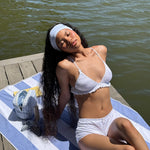 Infinity Headband in Baby Blue Gingham model leaning back in sun on dock while wearing Infinity Headband in Baby Blue Gingham