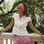 Infinity Headband in Cherry Gingham model standing against railing wearing Infinity Headband in Cherry Gingham in hair