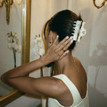 Heartbreaker Clip in Chantilly model looking in mirror with Heartbreaker Clip in Chantilly in hair