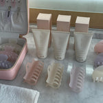 Heartbreaker Clip in Lilac Smoke assorted emi jay hair clips and vanity case with multiple bottles of Angel Hold on counter by towel