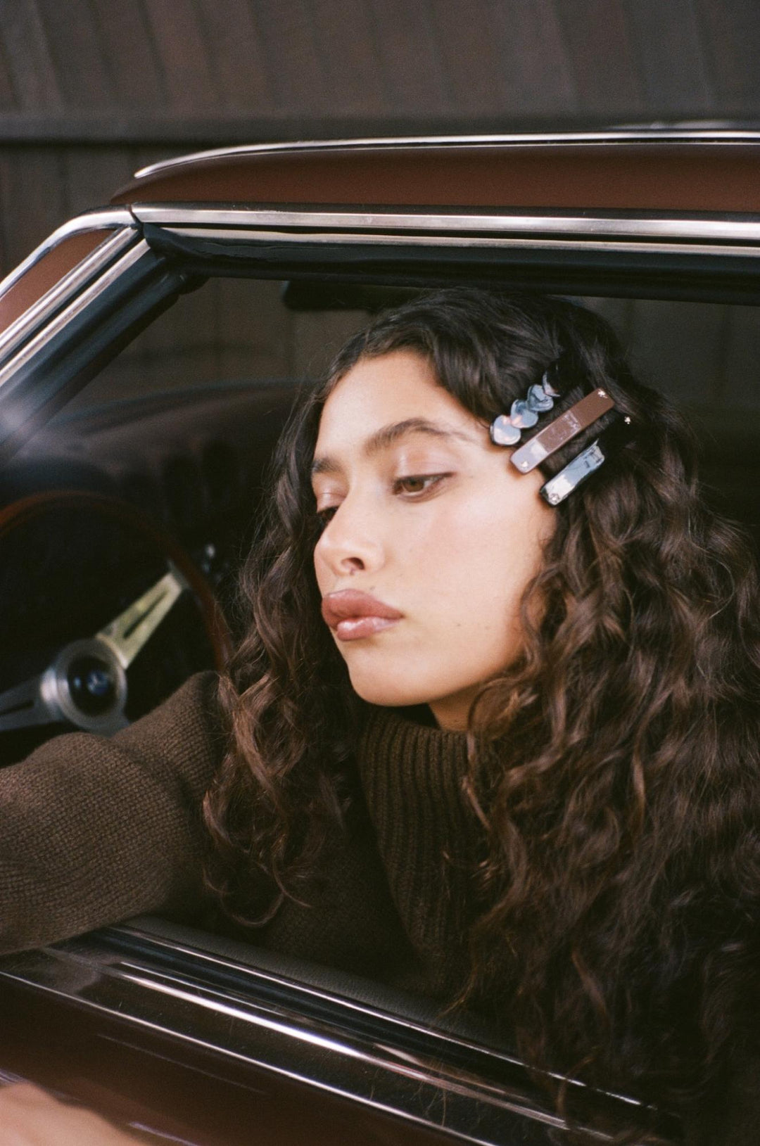 Model standing in front of car while using Aura Hair + Body Mist in Toasted Sugar. Model standing in front of car while using Aura Hair + Body Mist in Toasted Sugar.