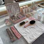 Infinity Headband in Grey Smoke assorted emi jay hair care and accessories on counter with emi jay towel, coffee, and vanity case