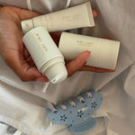 Lil Effing Clip in Blue Petal Eyelet model holding emi jay hair care products next to Lil Effing Clip in Blue Petal Eyelet