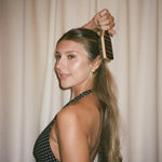 Mini Boar Bristle Brush in Nightcap model in polka dot dress brushing hair with Mini Boar Bristle Brush in Nightcap