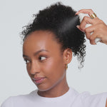Aura Hair + Body Mist™ in Angel Wings models spraying aura hair mist