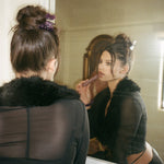 Princessa Clip in Plum model looking in mirror while wearing Princessa Clip in Plum
