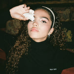 Starlet Headband in Snow model holding princessa clip while wearing startlet headband in snow