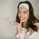 Ruffle Headband in Pointe model wearing Ruffle Headband in Pointe while holding big effing clip