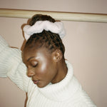 Sherpa Scrunchie in Milk model looking down while wearing Sherpa Scrunchie in Milk
