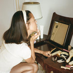 Starlet Headband in Chantilly model looking in mirror with Starlet Headband in Chantilly in hair