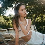 Starlet Headband in Melon Tart model sitting in truck bed wearing Starlet Headband in Melon Tart