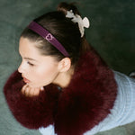 Starlet Headband in Rose Violet model leaning forward while wearing Starlet Headband in Rose Violet with star clips and sweetheart clip