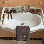 Styling Brush in Toasted Sugar Sink with Emi Jay embroidered towel and assorted Emi Jay hair care, accessories, and styling tools sinkside.