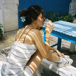 Super Bloom Clip in Mint Pearl model sitting with Super Bloom Clip in Mint Pearl in hair