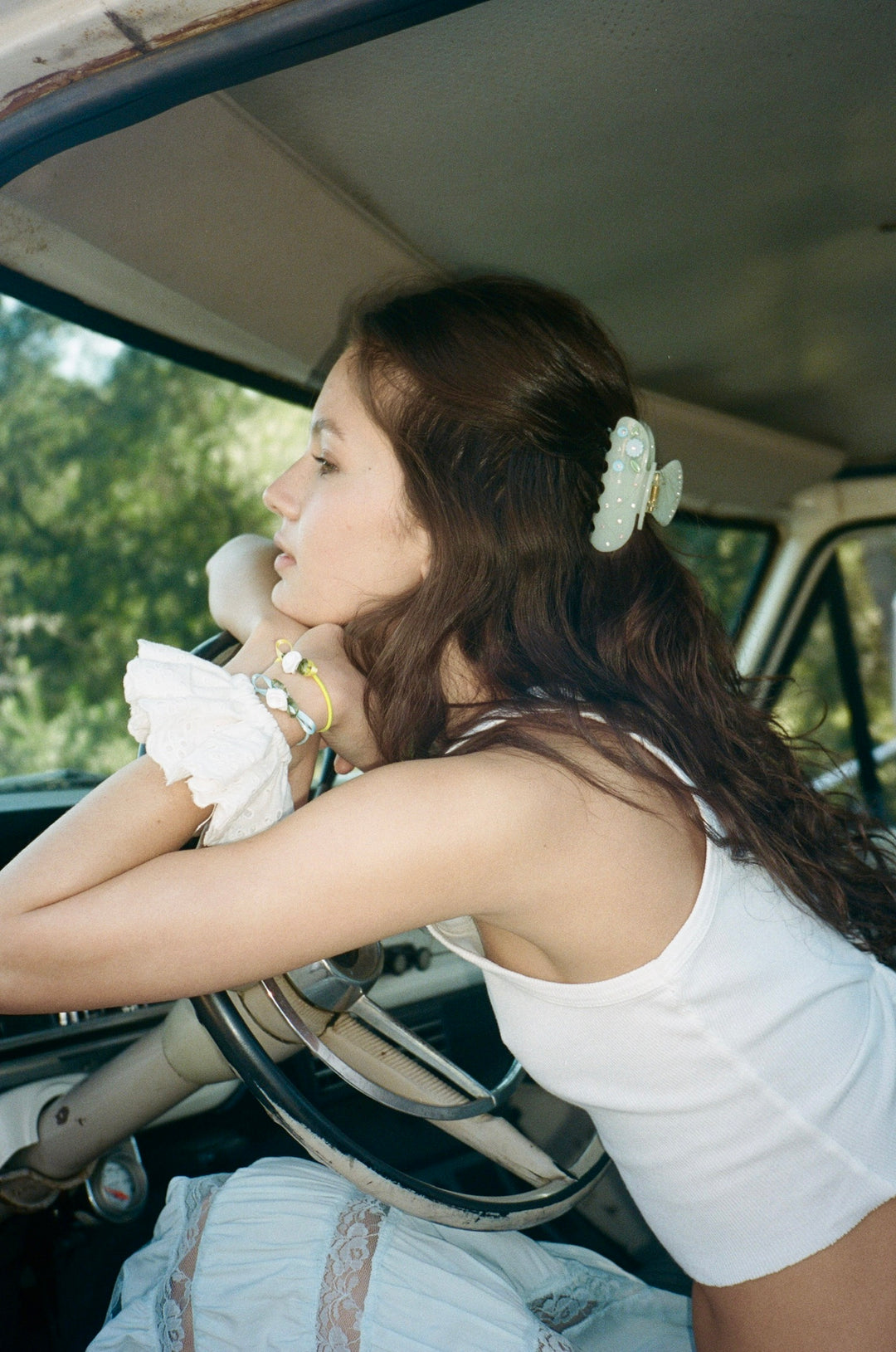 model leaning on truck while wearing sweet like honey scrunchie