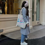 Emi Jay Ski Club Tote Bag model wearing Sugar Muffs with Emi Jay Ski Club Tote Bag over shoulder