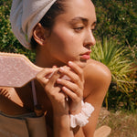 Bamboo Paddle Brush in Bellini model holding Bamboo Paddle Brush in Bellini