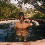 Bamboo Paddle Brush in Tortoise model brushing her hair with Bamboo Paddle Brush in Tortoise