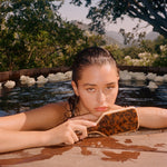 Bamboo Paddle Brush in Tortoise model holding Bamboo Paddle Brush in Tortoise