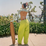 Big Effing Clip in Skate Princess Standing with skateboard and adjusting hair with Big Effing Clip in Skate Princess