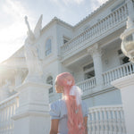 Butterfly Barrette Set in Dawn model standing by statue with Butterfly Barrette Set in Dawn + Dusk in hair