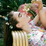 Baby Daisy Clip Set in Jade model laying with Baby Daisy Clip Set in Jade + Lychee + Aqua in hair