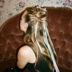 Baby Heartbreaker Clip Set in Pink Vanilla closeup of model sitting with Baby Heartbreaker Clip Set in Frosting + Pink Vanilla in hair