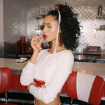 Baby Heart Clip Set in Cherry Kiss model standing with Baby Heart Clip Set in Cherry Kiss in hair