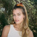 Big Effing Clip in Brown Sugar model looking at camera with Big Effing Clip in Brown Sugar in hair