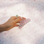 Big Effing Clip in Fairy Wings model holding Big Effing Clip in Fairy Wings in front of fabric